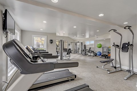 a gym with treadmills and other exercise equipment at the enclave at woodbury